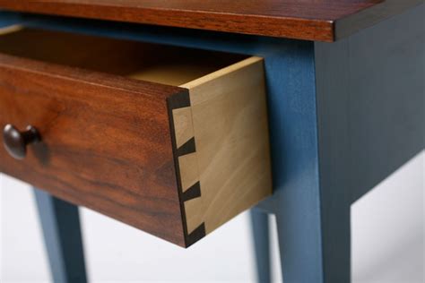 Dovetail furniture - A dovetail joint is a series of overlapping, flared connectors that join two pieces of wood. The connectors are called tails and pins. When viewing the face of the board, the tails resemble a dove’s tail. So do the pins when viewing the end grain. The gaps between tails are called pin sockets, with the gaps between pins known as tail sockets.
